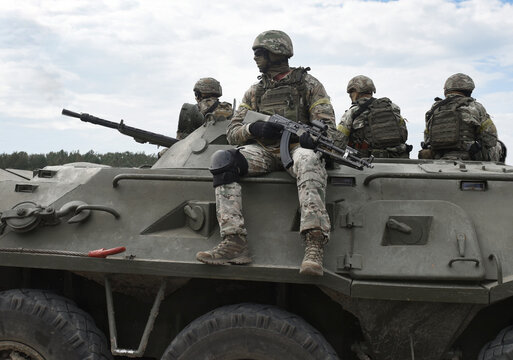 Soldiers with machine guns on an armored personnel carrier. Post-Soviet conflicts. Caucasus war