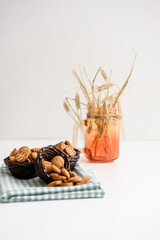Small cracker cookies in a basket on a linen napkin on a white background