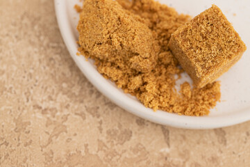 Panela sugar block and powder, its cane sugar, typical for Central and Latin America cuisine.