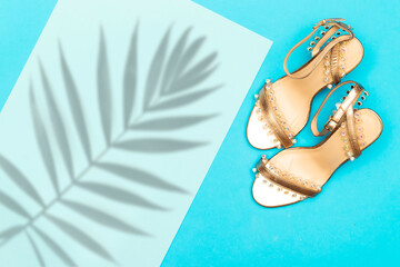 Elegant and stylish gold bridal shoes with leaf shadow