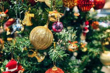 Shiny Christmas toys at new year tree. New year decorations. Christmas tree