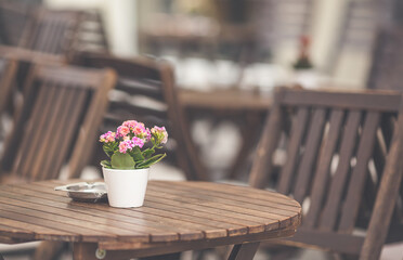 Restaurant exterior with flowers on the table at the city streets