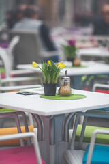 Restaurant exterior with flowers on the table at the city streets