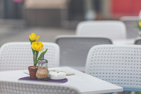 Restaurant exterior with flowers on the table at the city streets