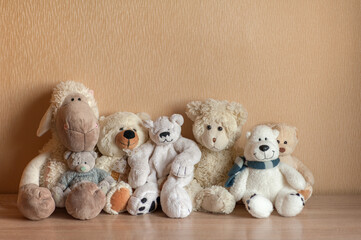 soft toys sit on a neutral background