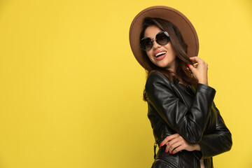 sexy young woman in leather jacket looking to side and smiling