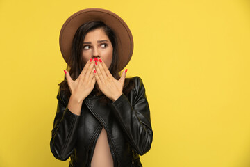 astounded young woman covering mouth with hands