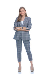 confident businesswoman in blue checkered suit crossing arms