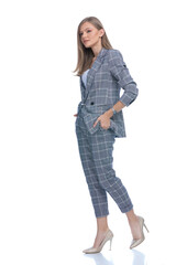 happy young woman holding hands in pockets