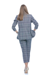 back view of woman holding hands in pockets