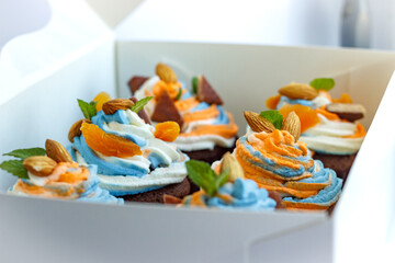Fresh tricolor cream cupcakes in a white package