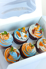 Fresh tricolor cream cupcakes in a white package