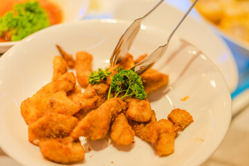 Hand of people take buffet food in hot pot restaurant.