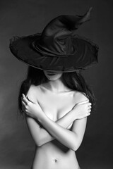 naked witch woman in hat. halloween concept