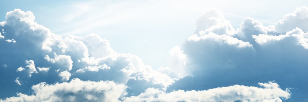 Clear blue sky with glowing white cumulus clouds after thunderstorm. Dramatic cloudscape. Concept art, meteorology, ecology, climate change, heaven, hope, peace, graphic resources. Panoramic view