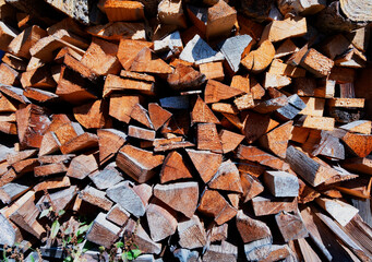 Firewood for the winter stacks of firewood pile of firewood. Firewood stacked