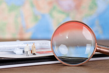 Crowd model boarding on the desk calendar and a magnifying glass