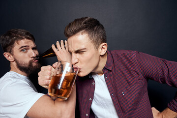 Two drunk friends drinking beer rest fun dark background