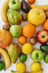 Close up of various colorful fresh summer fruits isolated over white background