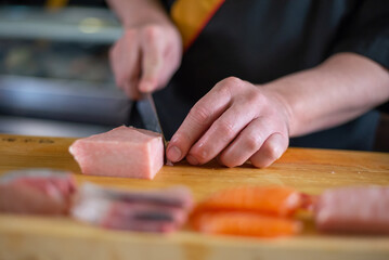 Japanese chef is neatly cutting on fine meat