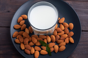 Almond milk in glass glasses on a dark wooden background. Copy space.
