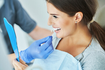 Male dentist and woman in dentist office