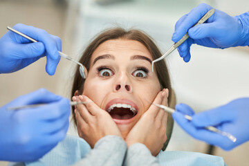Fototapeta premium Male dentist and woman in dentist office