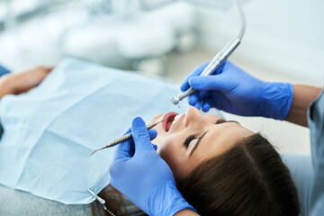 Male dentist and woman in dentist office