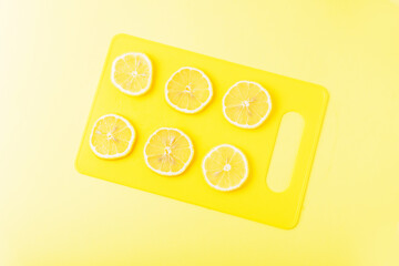 Lemon slices on a yellow Board close up