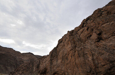Cliffs in the Gamkab valley of southern Namibia against a cloudy sky