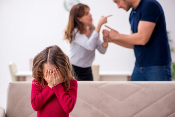 Young couple and their daughter in family conflict concept