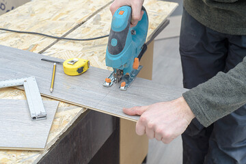  installing new laminated wooden floor. copy space