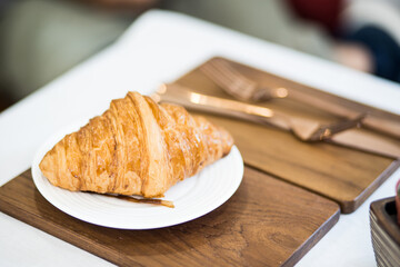 Freshly baked sweet croissants in coffee shop