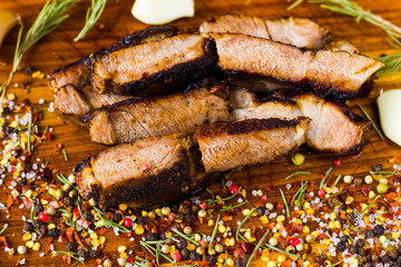 Beef steak on the wooden board, salt, pepper, onion and rosemary. Rib eye steak.