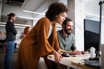 Happy young business people colleagues talking working in office