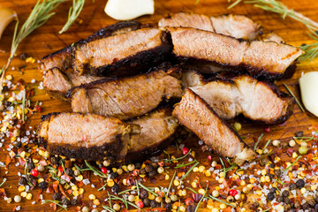 Beef steak on the wooden board, salt, pepper, onion and rosemary. Rib eye steak.