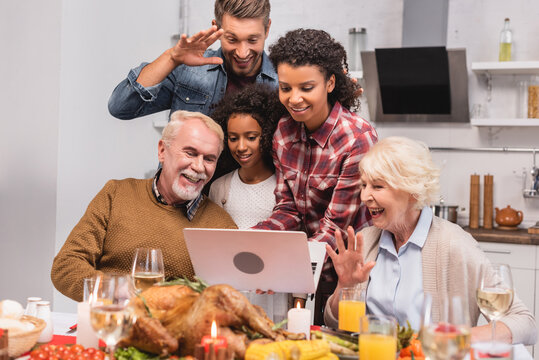 Selective Focus Of Multicultural Family Having Video Call On Laptop Near Food During Thanksgiving