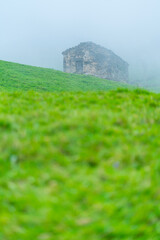 Fototapeta premium Cabañas Pasiegas and meadows, Miera Valley, Valles Pasiegos, Cantabria, Spain, Europe