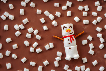 Melted marshmallow snowman swiming in a hot chocolate