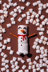Melted marshmallow snowman swiming in a hot chocolate