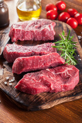 Raw beef steak on a cutting board - 381327447