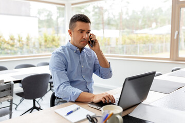 remote job, technology and business concept - middle-aged man with laptop computer calling on smartphone at home office