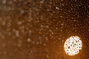 Raindrops in a window at night
