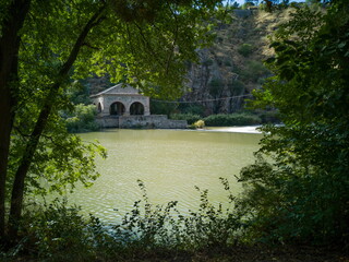 Old mill of the Tagus river as it passes through Toledo, Spain, next to the San Martín Bridge,