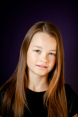 Fototapeta premium Portrait of a girl in a black T-shirt on a dark background