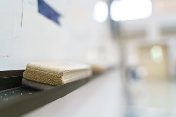 Whiteboard pen eraser with wooden handle with blue ink stain