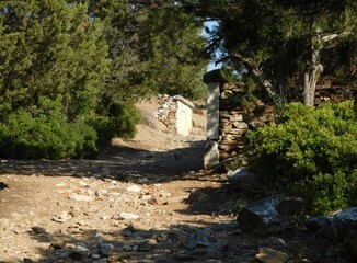 A road with burial enclosures, leading to the ancient city of Rhamnous, in Attica, Greece