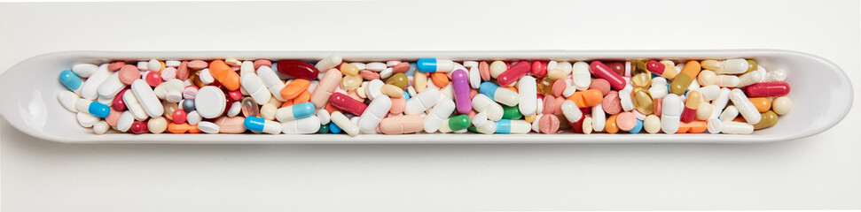 Colorful medicines drugs in an elongated bowl