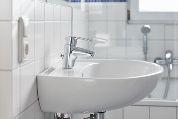 Sink with faucet in the bathroom at home