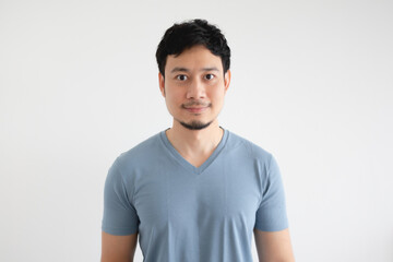 Portrait of happy Asian man in blue t-shirt on isolated white background.